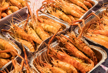 Fried king shrimps seafood by fire and BBQ Flames. Restaurant Barbecue at the night market