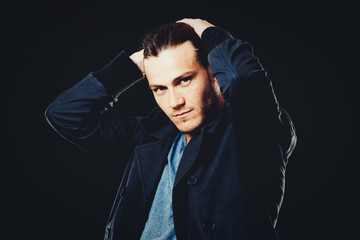 Fototapeta premium caucasian man wearing blue tshirt, black jacket and trendy hairstyle