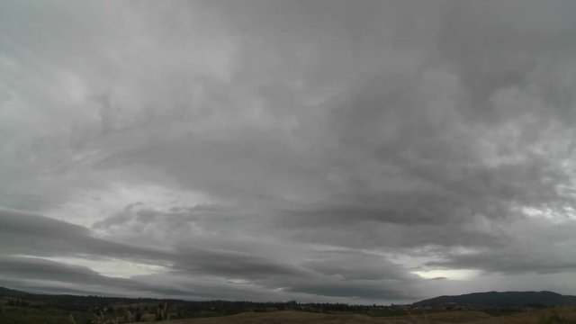 Dark rain clouds race across the sky near Talca, Chile.