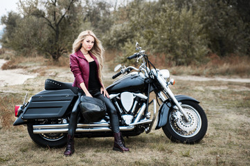 Fototapeta na wymiar Biker woman outdoor with a motorcycle.