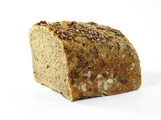 A piece of black bread with linseed and sunflower seed isolated on white background.
