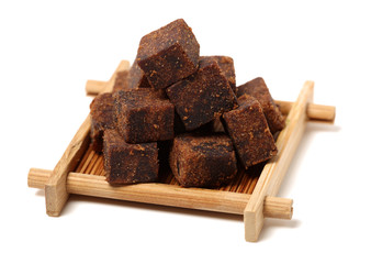 brown cubes of sugar on white background