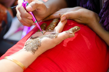 applying henna on hand, Hindu wedding ,Rajasthan, India