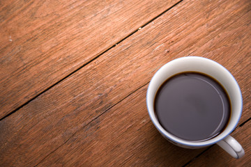 Coffee cup top view on wooden vintage table background