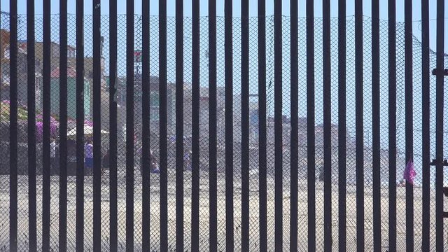 Mexican visit the beach at the U.S. Mexico border fence in the Pacific Ocean between San Diego and Tijuana.
