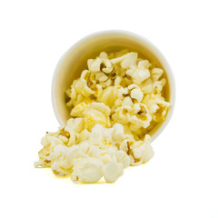 The popcorn is poured from a paper Cup isolated on a white background.