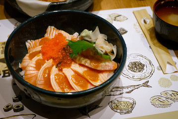 Raw salmon slice or salmon sashimi in Japanese style fresh serve on ice with fresh wasabi, Japanese traditional food.