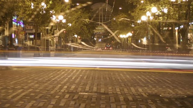 Traffic drives through a downtown area in time lapse.