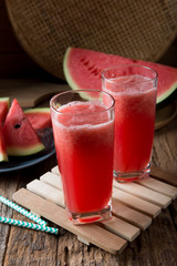 Watermelon smoothie on wood background