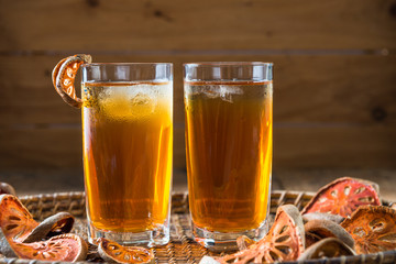 Bael juice ice tea on wooden table , healthy drink