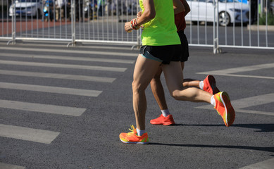 marathon runners legs running on city road