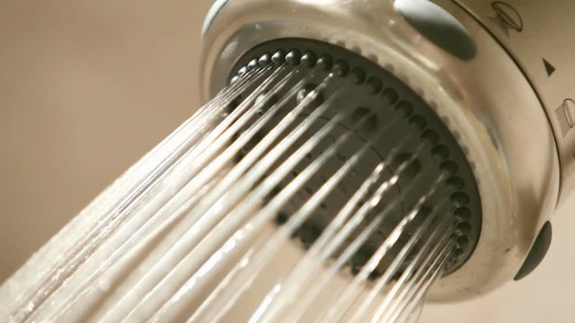 A shower head turns on, then off.
