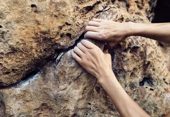 Foto op Canvas woman climber hands climbing on cliff edge © lzf