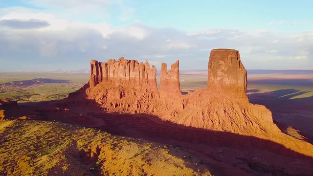 Beautiful inspiring aerial at sunset over rock formations in Monument Valley, Utah.