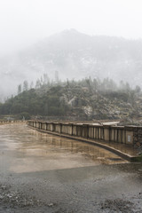 Fogs Among Trees, Dam, and Mountains on a Rainy Day in Hetch Hetchy Reservoir Area in Yosemite National Park, California