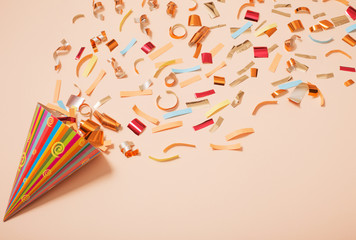 birthday hat with confetti on paper background