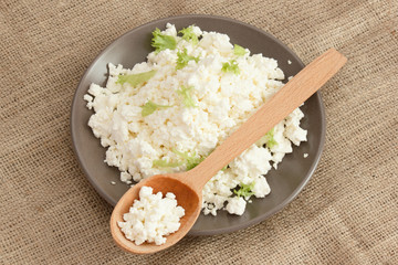 Natural crumbly cottage cheese on burlap