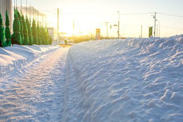 Path walking way to my home with snowy on winter season in sunset time.