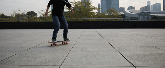 female skateboarder riding with skateboard on city