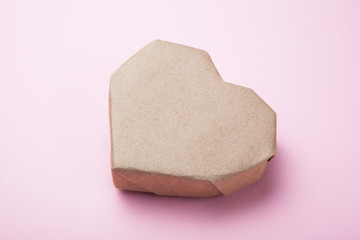 Paper heart on a pink background.