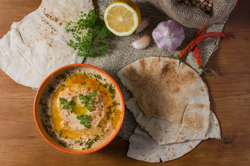 Lebanese hummus salad on rustic wooden table