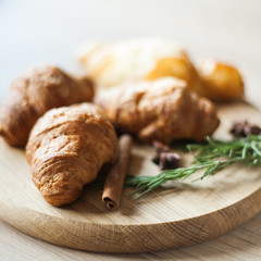 croissants with chinnamoon and anise on wooden stand