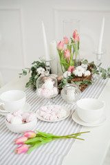 cup and white and pink marshmallow on decorated table
