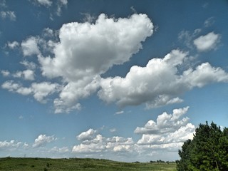 Fototapeta na wymiar Countryside surrounded by big beautiful fields and a cloudy sky
