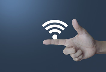 Wifi icon on finger over light gradient blue background, Technology and internet concept