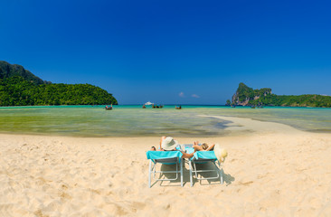Fototapeta na wymiar Couple on the beach at tropical resort on Phi Phi island in Thailand