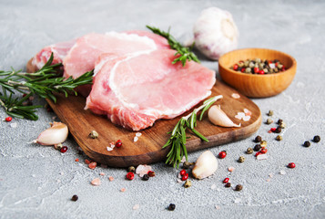 Fresh raw pork chops with spices and herbs