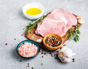 Fresh raw pork chops with spices and herbs