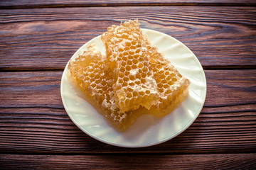     honey in honeycombs on a white plate