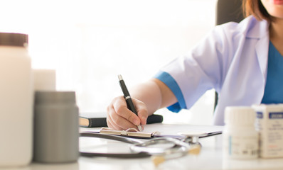 Female doctor take a note on clipboard , Medical concept