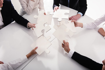 Teamwork of partners. Concept of integration and startup with puzzle pieces