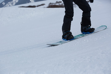 Fototapeta na wymiar one snowboarder snowboarding in winter mountains