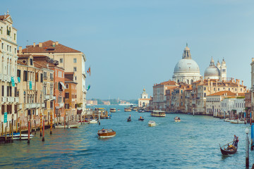 Fototapeta na wymiar Basilica Santa Maria della Salute, Venice, Italy. Landscape Grand Canal with gondolas and boats.