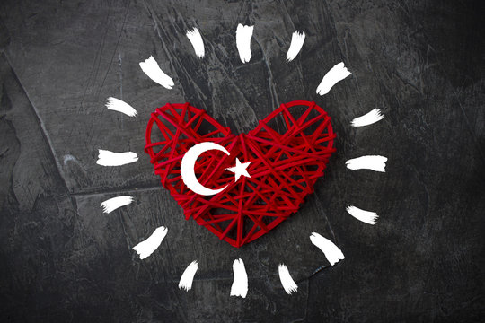 Heart with sun rays and flag of Turkey on a dark background. Theme of rest and travel 1