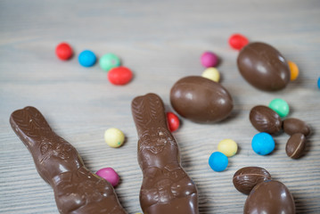 Delicious chocolate easter eggs ,bunny and sweets on dark wood background
