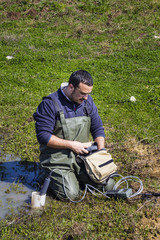 Scientist measuring environmental water quality in a wetland