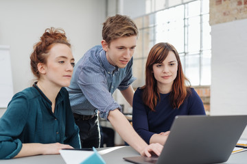 Young business team working together on a laptop