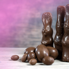 Delicious chocolate easter eggs ,bunny and sweets on dark wood background