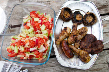 Vegetable salad and grilled meal outdoor