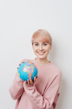 Pretty woman with short haircut holding globe