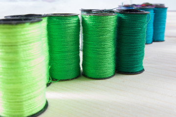 Rainbow of colourful thread spools on the table