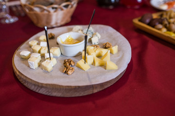 Cheese plate. Cheese plate served with nuts and honey. Food