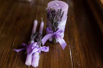 Three purple candles decorated with lavender branches. Wedding