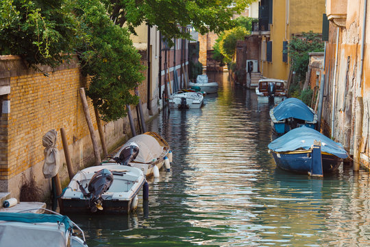 View of venetian narrow canal. Venice is a popular tourist destination of Europe.