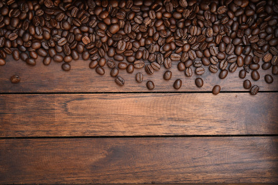 Close up of coffee beans on wooden background