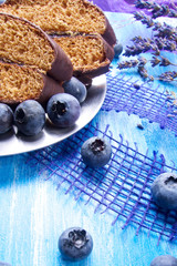 Blueberries and chocolate with lavender and spoon on wooden board